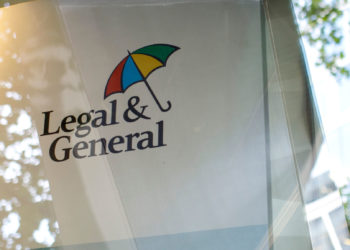 People walk past Legal and General offices on 1 Coleman St in London on August 1, 2018.