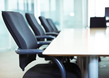 Empty chairs in a business boardroom. Very narrow depth of field shot with Tilt Shift.