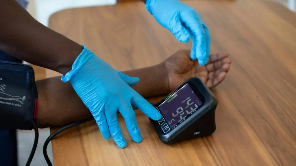 Paciente en hospital de Estados Unidos con documentos de seguro de salud, reflejando alza en costos médicos.